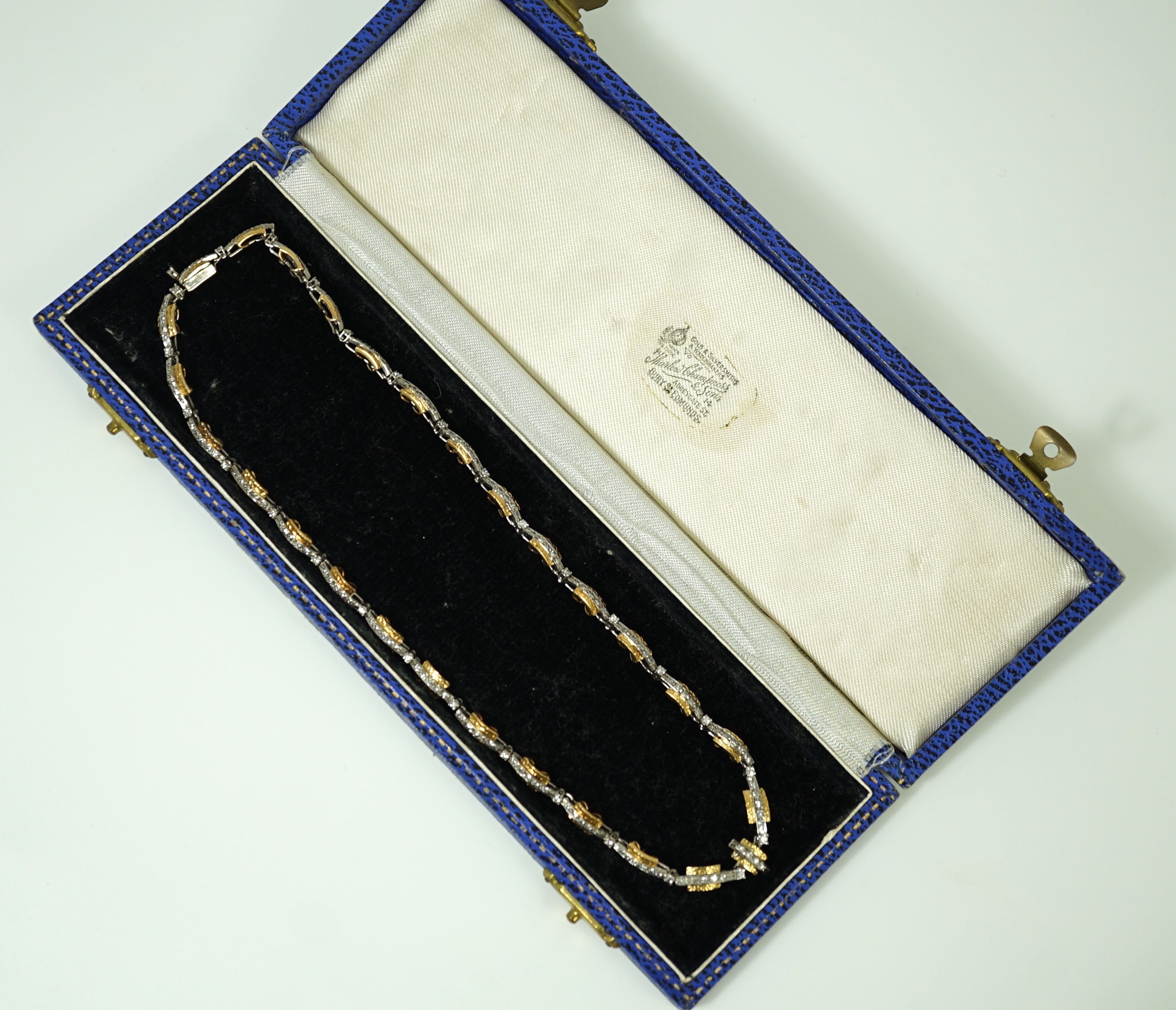 A 20th century two colour gold and diamond set necklace